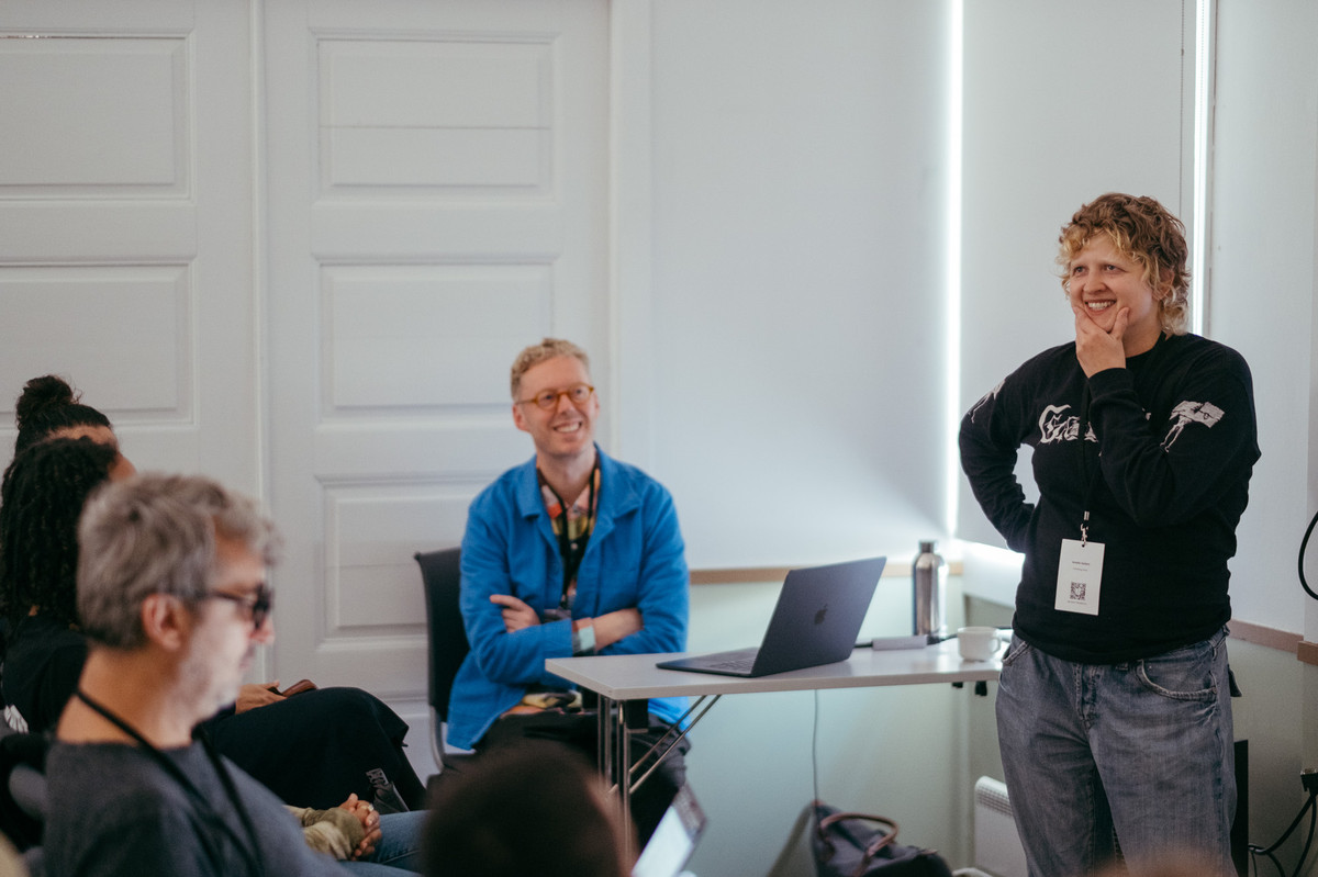 Artist presentation by Anette Gellein with Kenneth Varpe in the background at Sogndalstrand kulturhotell. Photo by Tiny Productions for Coast Contemporary.