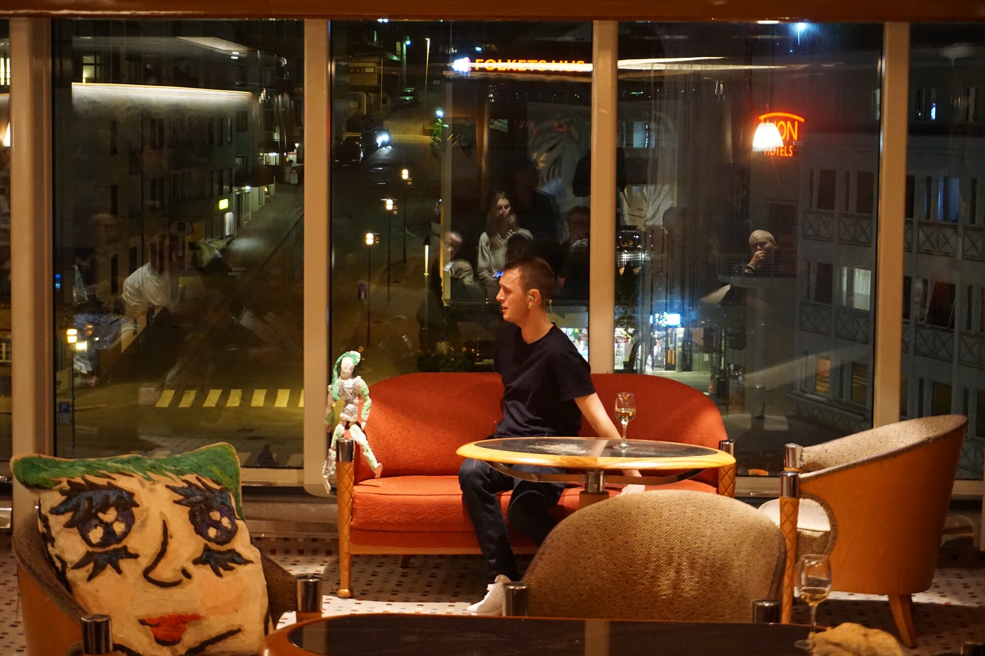 Nils Bech performing as we enter the harbor in Molde. Sculptures by Ida Ekblad.