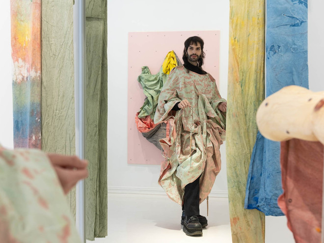 Visitor testing out the wearable textile sculptures by Hammonds. Photo by SOFT gallery.