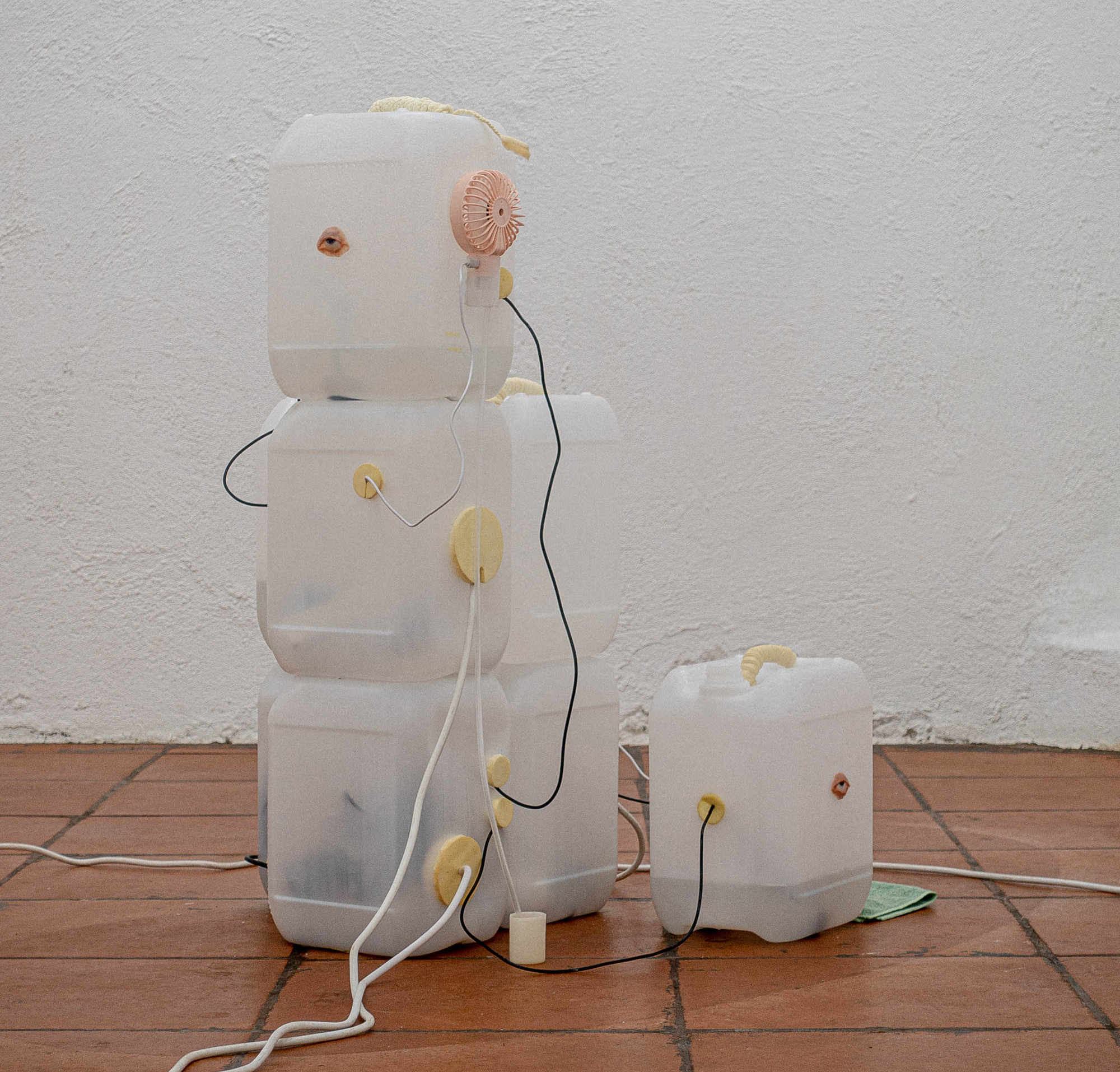 ...And Slumber Might Return.
Site specific installation for Hulias, Oslo, 2021. Candles infused with CBD, modified water containers (10 l), tinctures of mugwort, st.johns wort and blue
lotus, ultrasonic fog maker, usb fan, rubber foam, beeswax, nail acrylics, extension cord, electric timer, PVC
pipe. Photo: Jørn Aagaard