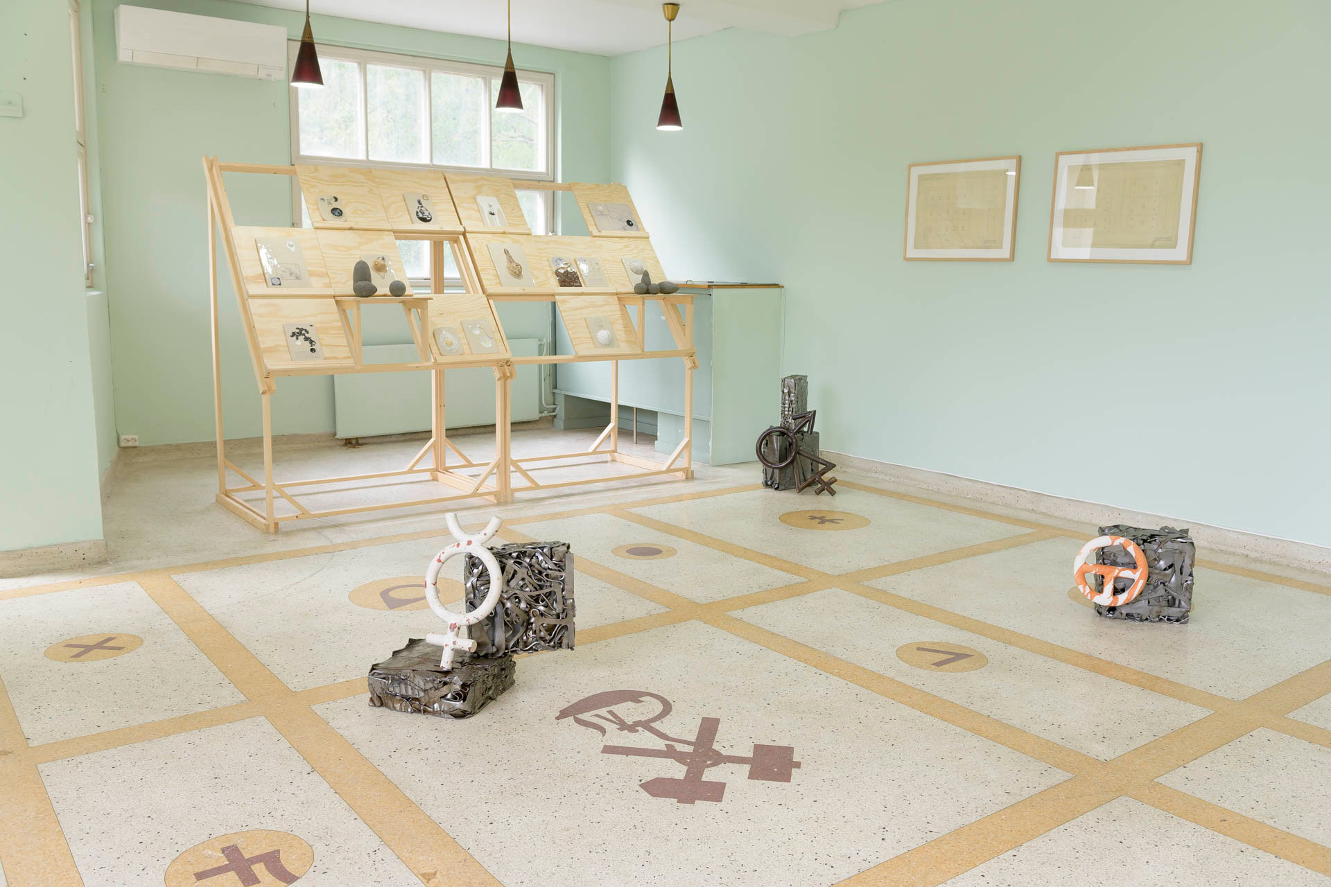 Descend and Dwell. Marte Johnslien, 2024 (work in progress). Installation with ceramic tablets made with titanium dioxide and related minerals in conjunction with archival images from the titanium dioxide companies. Velferden Sokndal scene for samtidskunst, 2024. Photo: Hans Edward Hammonds.